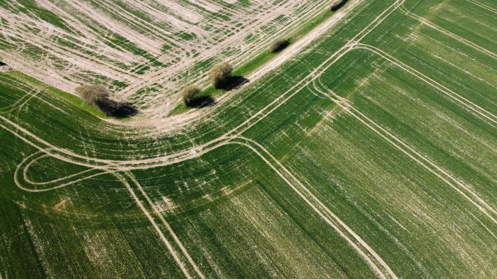 Drone shot of agricultural fields in Central Bedfordshire, England, displaying farm patterns.