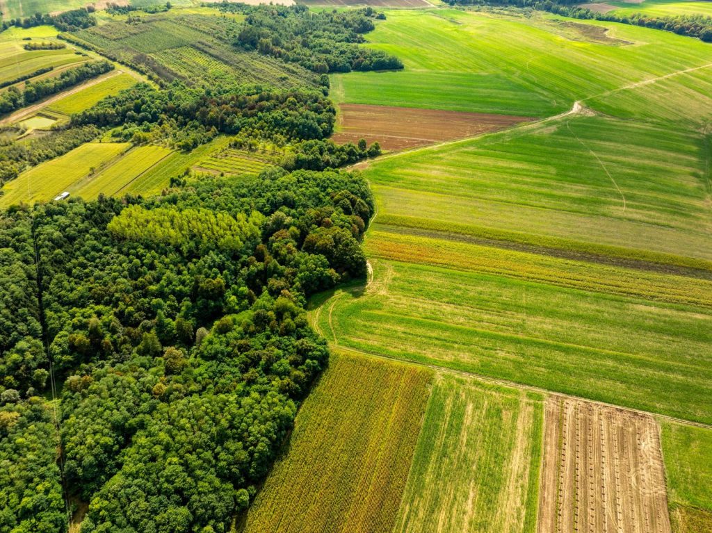 Aerial landscape of vibrant fields and dense forest in Garešnica, Croatia.